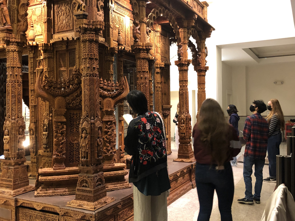 People studying an artifact 