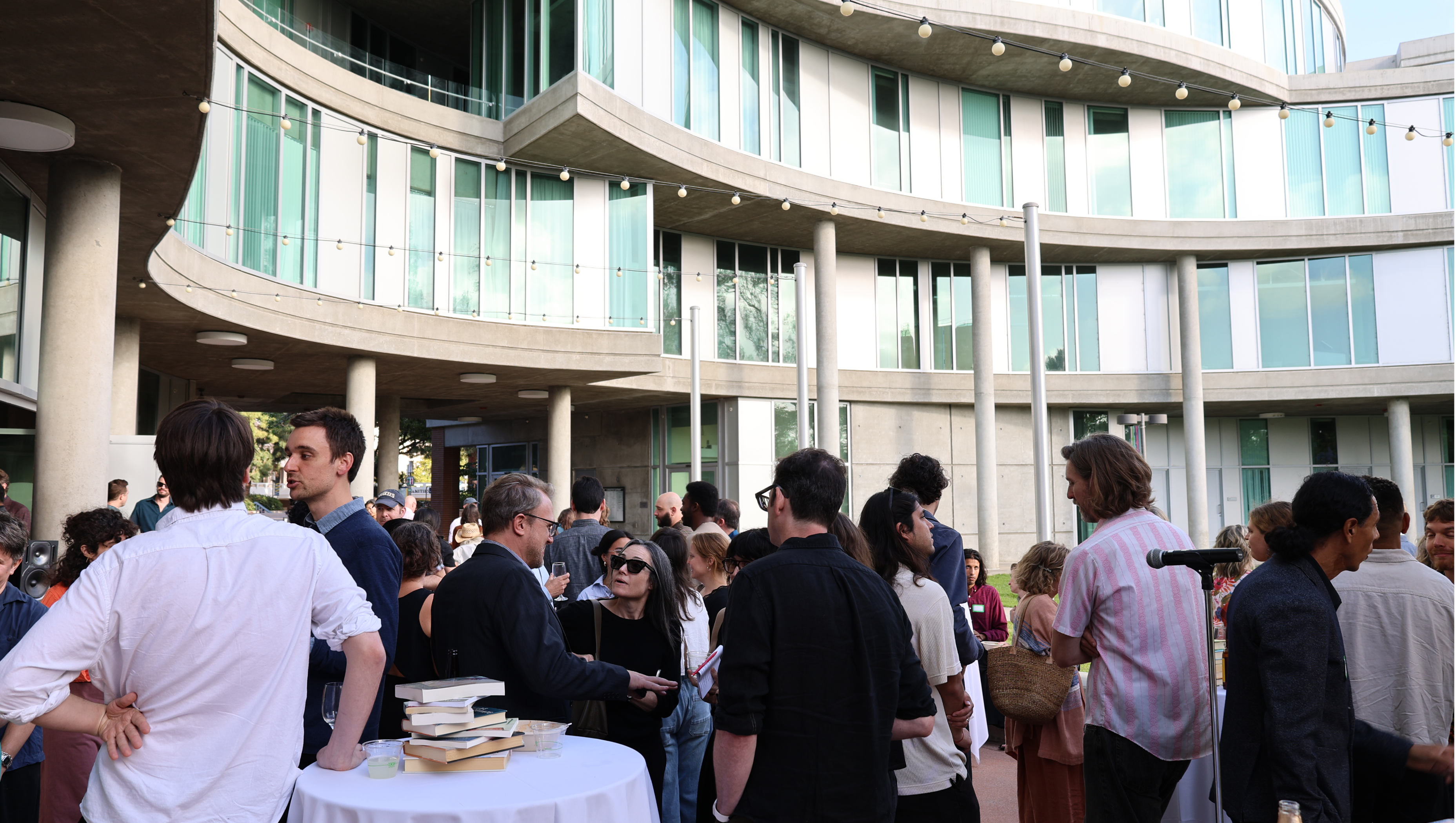 A crowd of people attending an event in front of UC Irvine Humanities Gateway.
