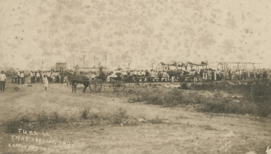 June 19, Emancipation Day. Corpus Christi, 1913. Image of a group gathered in and around a grandstand for Juneteenth celebrations.